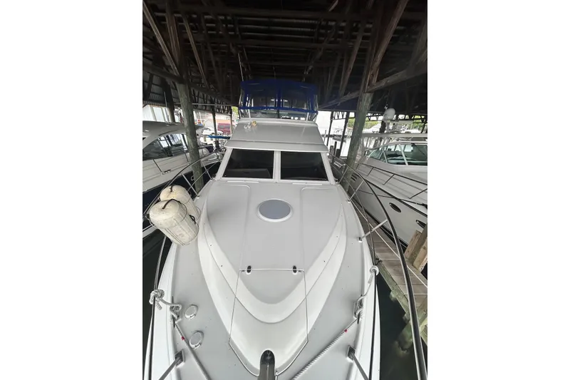 Slide: The Image of 2001 Cruisers Yachts 3750 Motoryacht docked in a covered marina. - 3