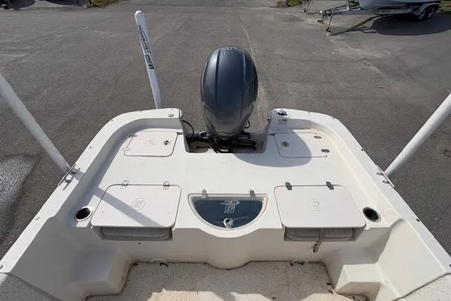 Slide: The Image of 2019 Carolina Skiff 218 DLV boat stern view with motor and storage compartments. - 4