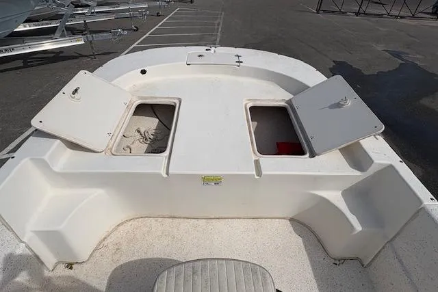 Slide: The Image of 2019 Carolina Skiff 218 DLV boat deck with open storage compartments. - 7