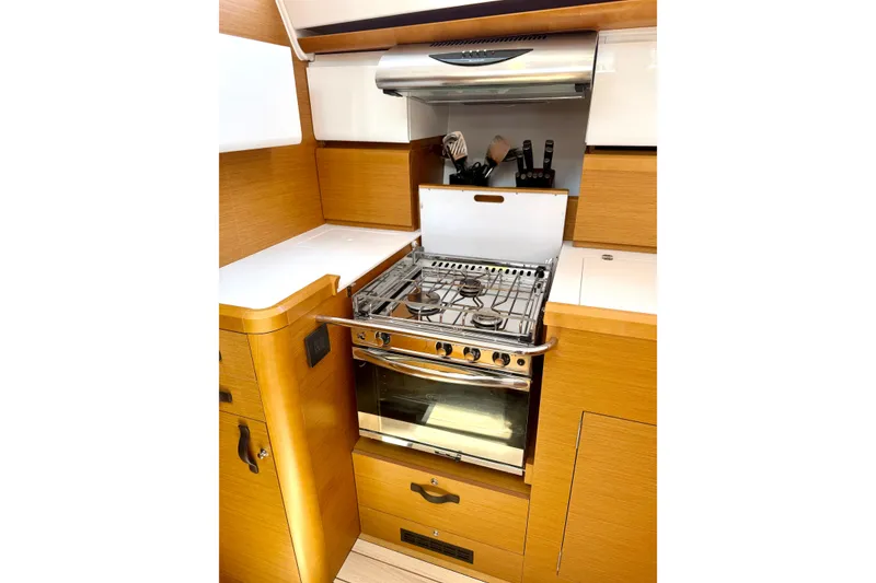 Slide: The Image of Modern kitchen in 2018 Jeanneau 58 yacht with stove and wooden cabinetry. - 12
