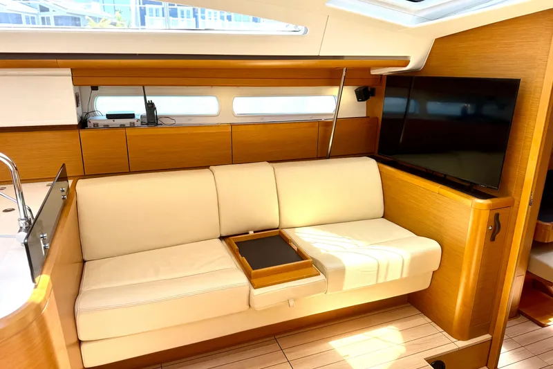 Slide: The Image of Luxurious interior of 2018 Jeanneau 58 yacht with modern furnishings and large TV. - 13