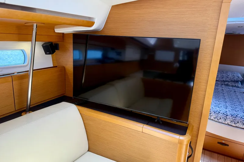 Slide: The Image of Interior of 2018 Jeanneau 58 yacht with TV, sofa, and cabin view. - 14