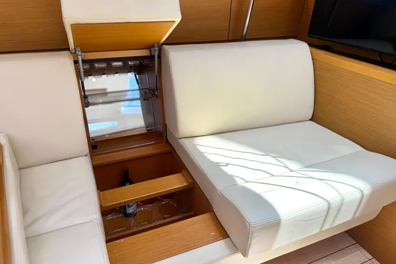 Slide: The Image of Interior of 2018 Jeanneau 58 yacht with hidden storage under white seating. - 15
