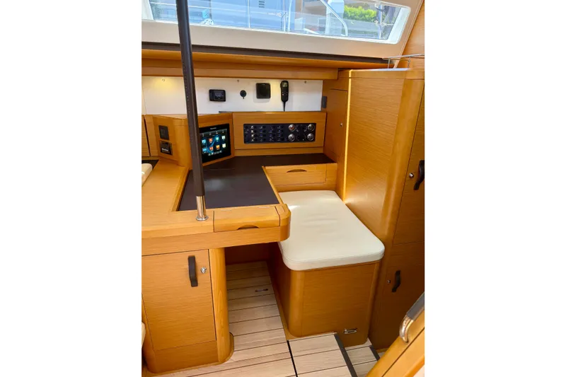 Slide: The Image of Interior of 2018 Jeanneau 58 yacht with navigation station and wooden cabinetry. - 16
