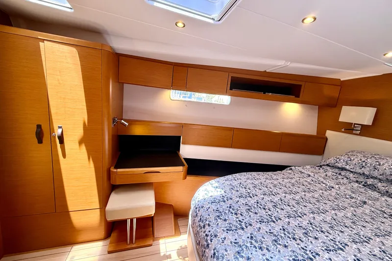 Slide: The Image of Luxurious 2018 Jeanneau 58 yacht cabin with wood finish and cozy bedding. - 18