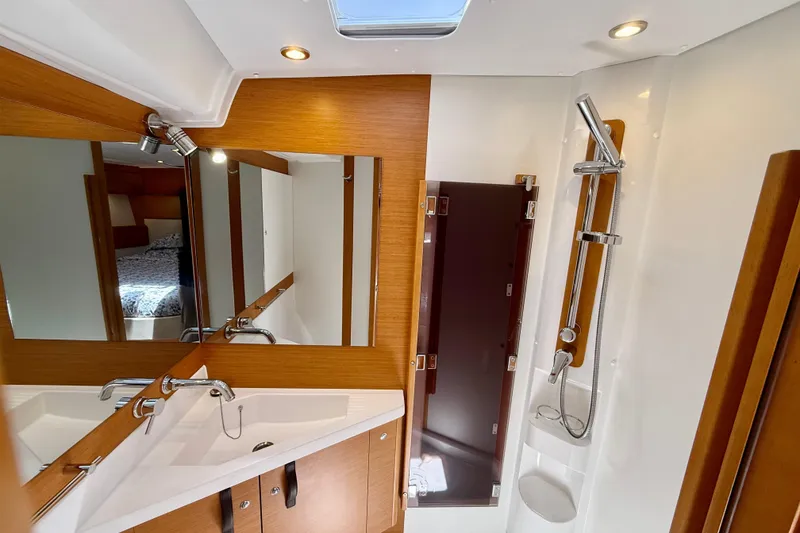Slide: The Image of Luxurious bathroom interior of 2018 Jeanneau 58 yacht with modern fixtures and wood accents. - 21