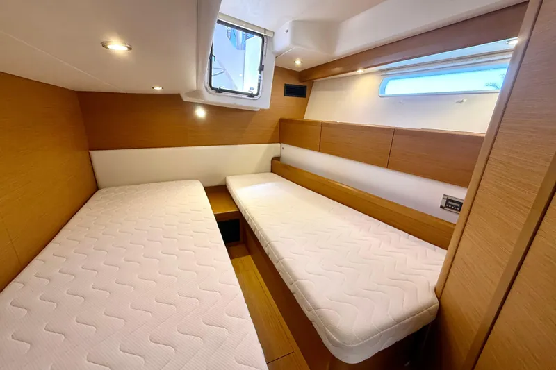 Slide: The Image of Interior cabin of 2018 Jeanneau 58 yacht with twin beds and wooden finish. - 23