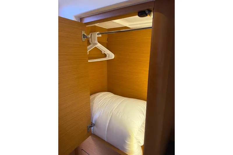 Slide: The Image of Wooden closet with hangers and bedding inside Jeanneau 58 yacht, 2018 model. - 24