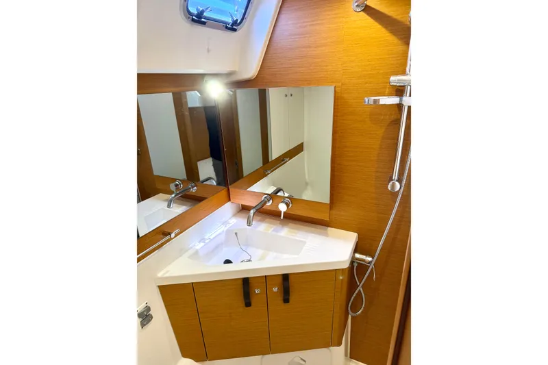 Slide: The Image of Luxurious bathroom in 2018 Jeanneau 58 yacht with modern fixtures and wooden cabinetry. - 25