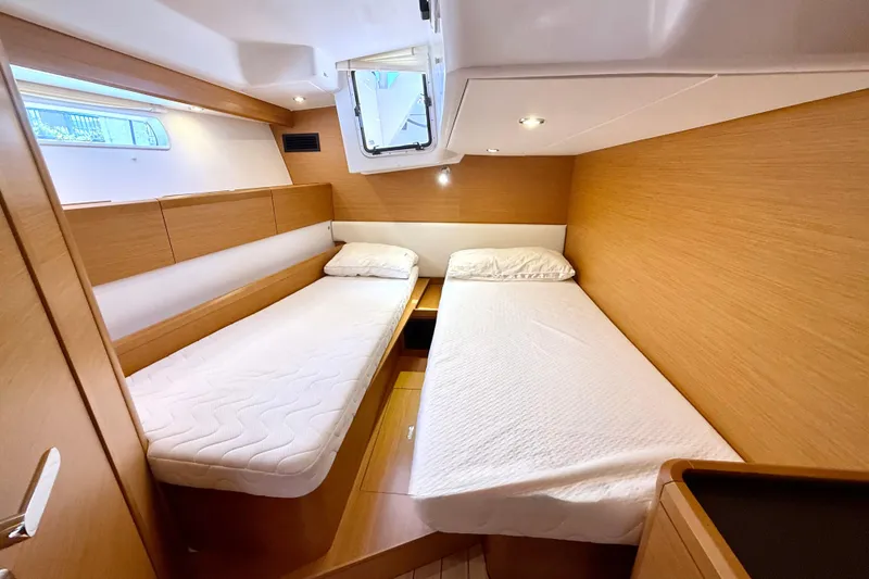 Slide: The Image of Luxurious cabin interior of 2018 Jeanneau 58 yacht with twin beds and wooden finish. - 26