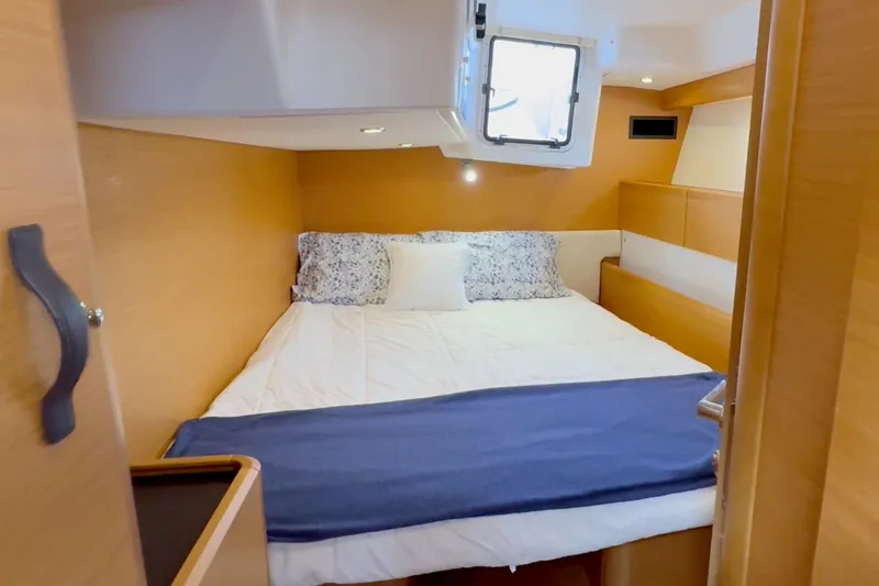 Slide: The Image of Cozy cabin interior of 2018 Jeanneau 58 yacht with bed and window. - 27