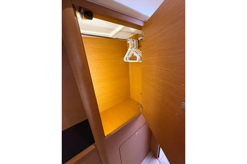 Slide: The Image of Wooden closet interior with hangers on a Jeanneau 58 yacht, 2018 model. - 29