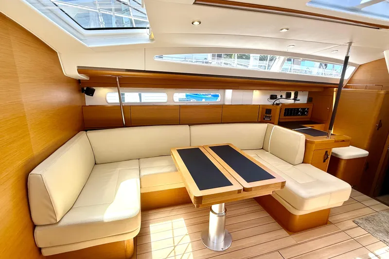 Slide: The Image of Luxurious interior of a 2018 Jeanneau 58 yacht with elegant seating and wooden finishes. - 3