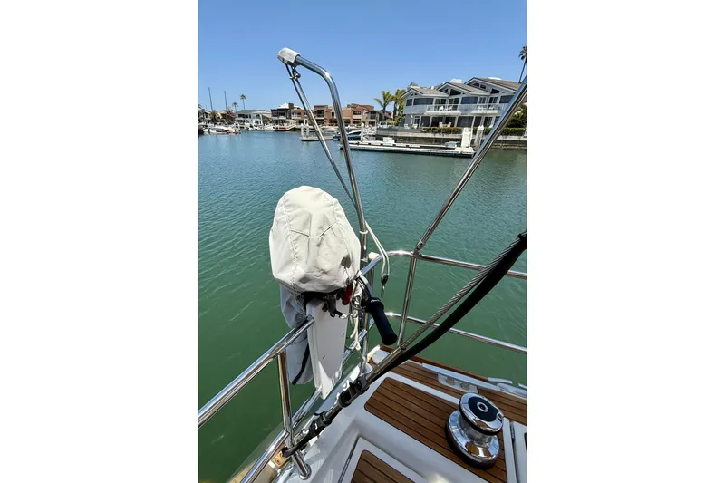 Slide: The Image of Jeanneau 58 sailboat deck view, 2018 model, overlooking marina with waterfront homes. - 36