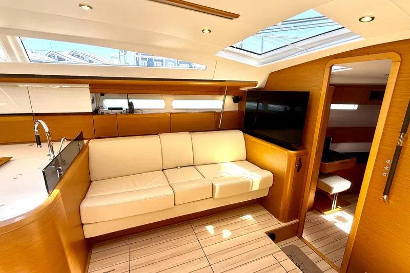 Slide: The Image of Luxurious interior of a 2018 Jeanneau 58 yacht with modern furnishings and ample natural light. - 4