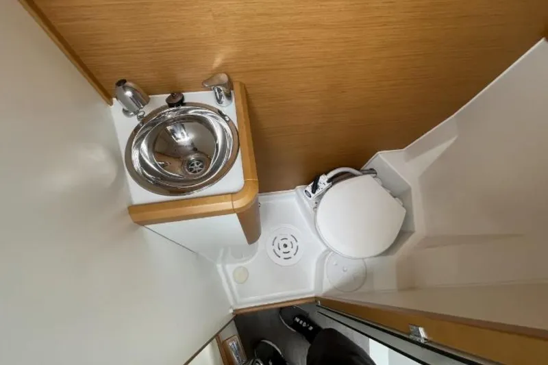 Slide: The Image of Compact bathroom in a 2018 Jeanneau 58 yacht, featuring a sink and toilet. - 44