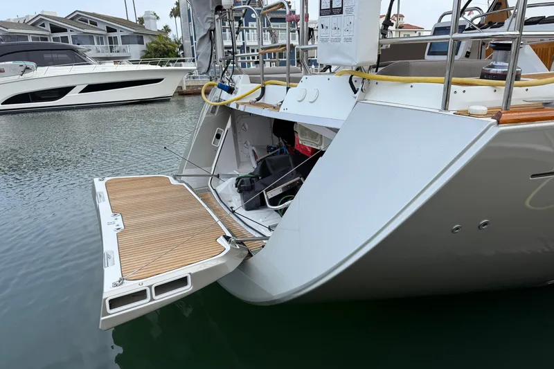 Slide: The Image of 2018 Jeanneau 58 yacht with open swim platform in marina setting. - 45