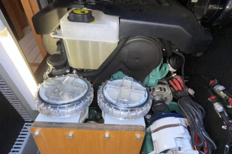 Slide: The Image of Engine compartment of a 2018 Jeanneau 58 yacht, showcasing mechanical components. - 49