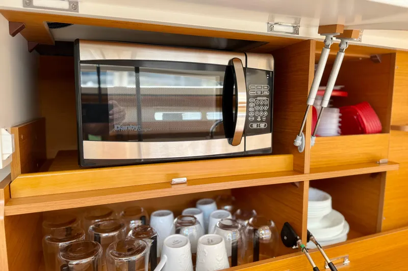 Slide: The Image of Microwave and kitchenware in Jeanneau 58 yacht's wooden cabinet, 2018 model. - 6