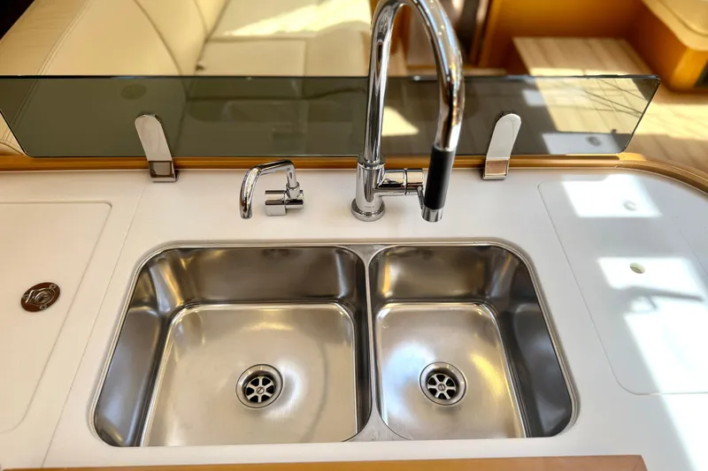 Slide: The Image of Luxury kitchen sink on 2018 Jeanneau 58 yacht, featuring dual basins and modern faucet. - 8
