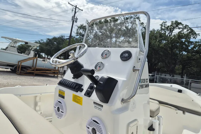 Slide: The Image of 2026 Key West 1720 Center Console boat with steering wheel and gauges, parked outdoors. - 3