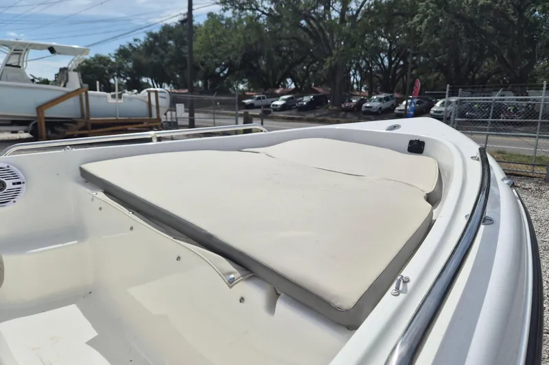 Slide: The Image of 2026 Key West 1720 Center Console boat with cushioned seating, parked outdoors. - 5