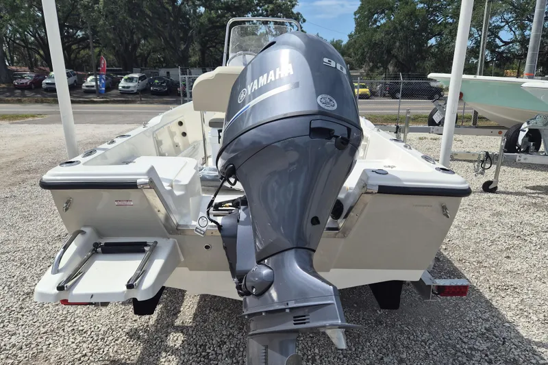 Slide: The Image of 2026 Key West 1720 Center Console boat with Yamaha 90 outboard motor, parked on gravel. - 8