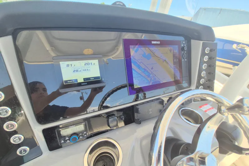 Slide: The Image of 2023 Robalo R230 Center Console dashboard with navigation and control displays. - 11