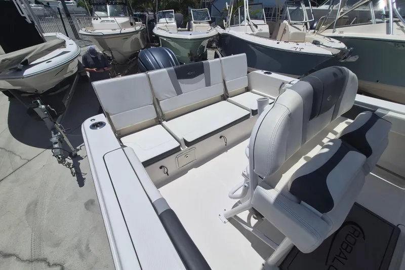 Slide: The Image of 2023 Robalo R230 Center Console boat interior with seating and storage. - 6