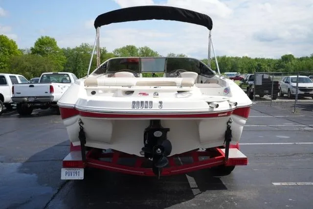 Slide: The Image of 2015 Stingray 208 LR boat with canopy, parked in a lot, rear view. - 13