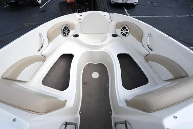 Slide: The Image of Interior of a 2015 Stingray 208 LR boat with beige seating and speakers. - 17