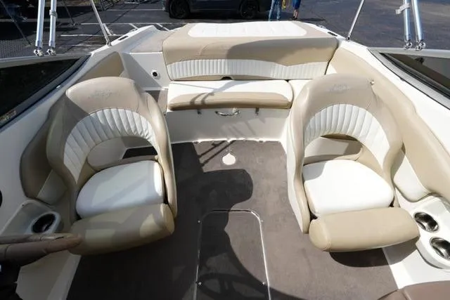 Slide: The Image of Interior of a 2015 Stingray 208 LR boat with beige and white seating. - 19