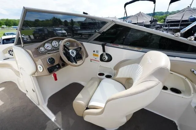 Slide: The Image of Interior of a 2015 Stingray 208 LR boat with steering wheel and gauges. - 20