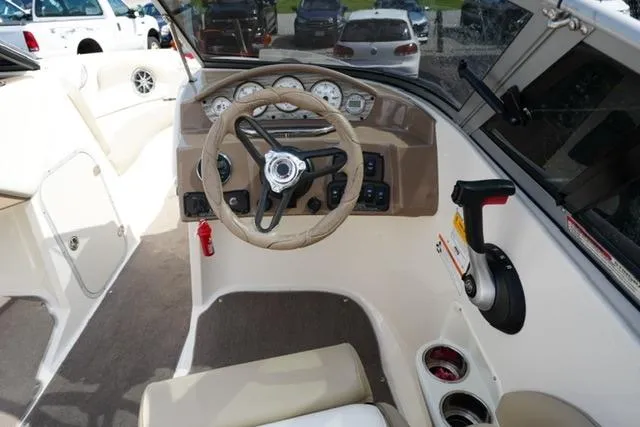 Slide: The Image of Cockpit of 2015 Stingray 208 LR boat with steering wheel and control panel. - 21
