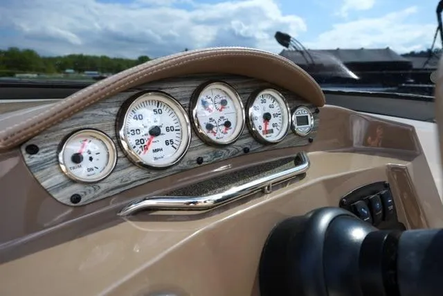 Slide: The Image of Dashboard of a 2015 Stingray 208 LR boat with gauges and controls. - 22