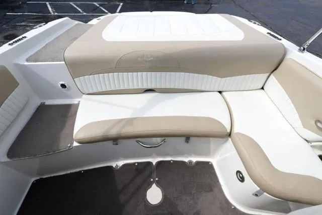 Slide: The Image of 2015 Stingray 208 LR boat interior with beige and white seating. - 23