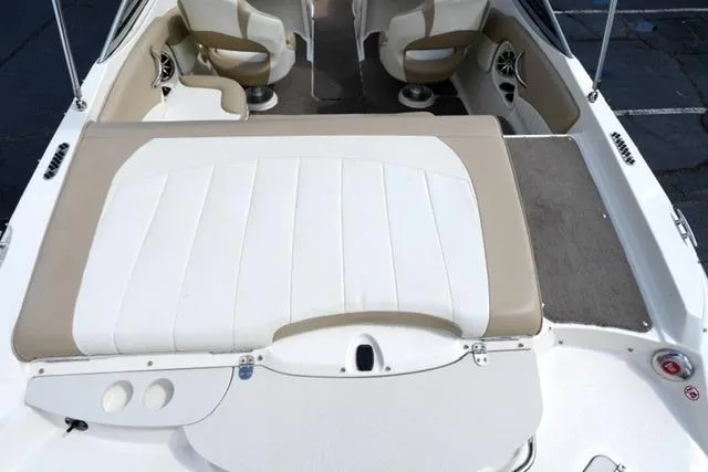 Slide: The Image of 2015 Stingray 208 LR boat interior with beige and white seating. - 25