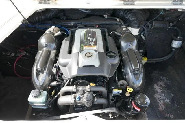 Slide: The Image of Engine compartment of a 2015 Stingray 208 LR boat, showcasing detailed components. - 26