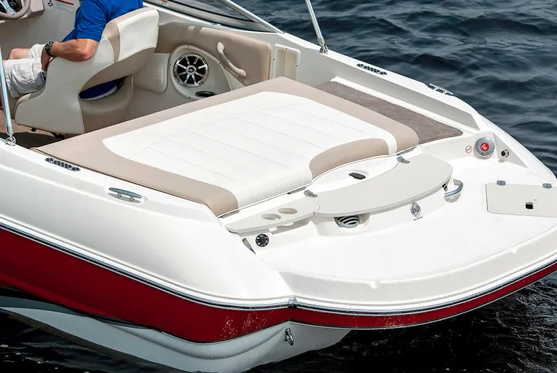 Slide: The Image of Manufacturer Provided Image: 2015 Stingray 208 LR boat with white and beige seating on water. - 7