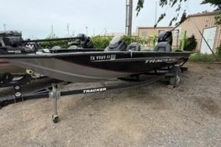 The Image of 2019 Tracker Pro Team 175 TXW fishing boat on trailer, parked outdoors. - 0