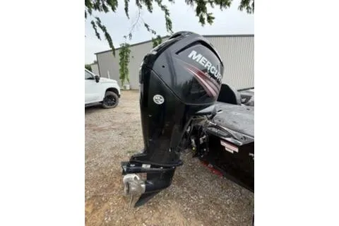 Slide: The Image of 2019 Tracker Pro Team 175 TXW with Mercury outboard motor, parked outdoors. - 10