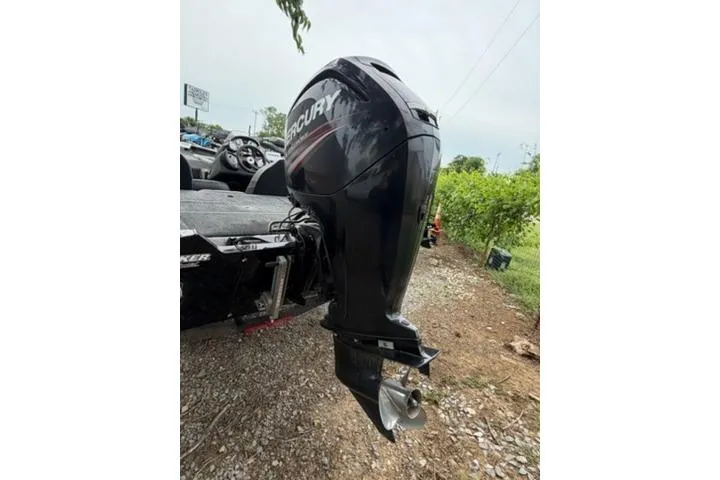 Slide: The Image of 2019 Tracker Pro Team 175 TXW boat with Mercury outboard motor, parked on gravel. - 8