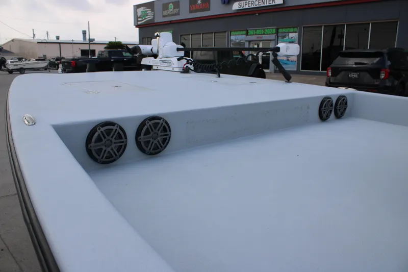 Slide: The Image of 2019 JH Performance Outlaw 230 boat deck with speakers, parked outside a marine supercenter. - 16
