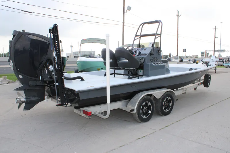 Slide: The Image of 2019 JH Performance Outlaw 230 boat on trailer, featuring sleek design and powerful outboard motor. - 2