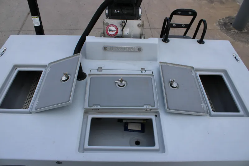 Slide: The Image of 2019 JH Performance Outlaw 230 boat deck with open storage compartments. - 22