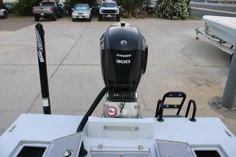 Slide: The Image of 2019 JH Performance Outlaw 230 with Evinrude 300 engine, parked on concrete. - 23