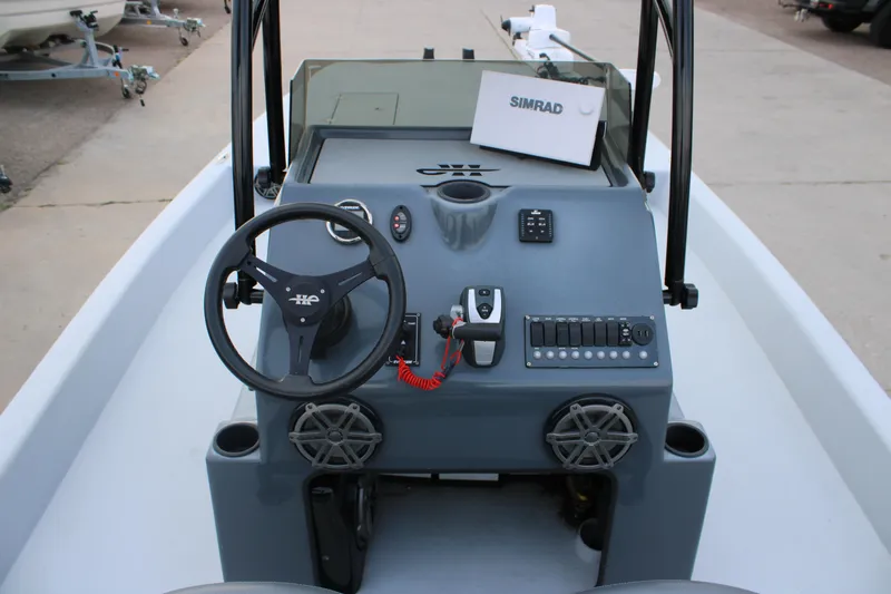 Slide: The Image of 2019 JH Performance Outlaw 230 boat dashboard with steering wheel and controls. - 5