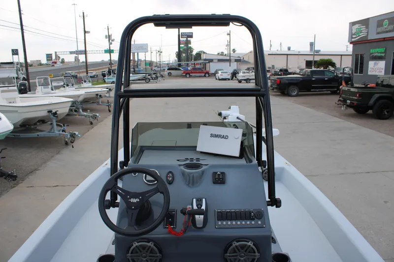 Slide: The Image of 2019 JH Performance Outlaw 230 boat dashboard with steering wheel and Simrad electronics. - 7