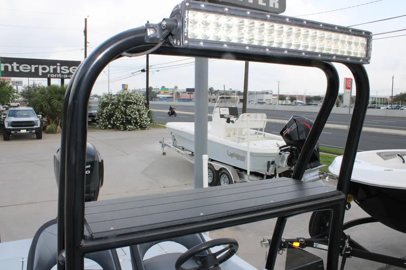 Slide: The Image of 2019 JH Performance Outlaw 230 boat with LED light bar, parked near a road. - 9