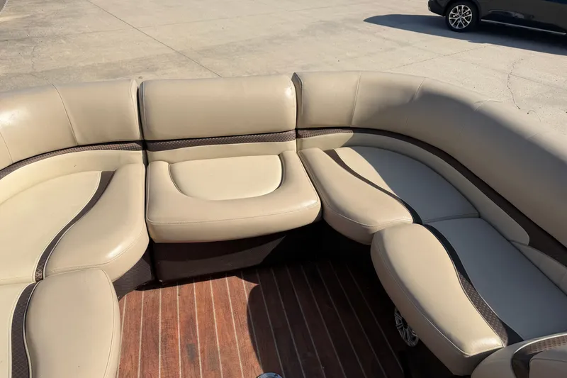 Slide: The Image of Beige seating on 2015 Crest Classic 230 SLC boat, wooden floor, outdoor setting. - 11